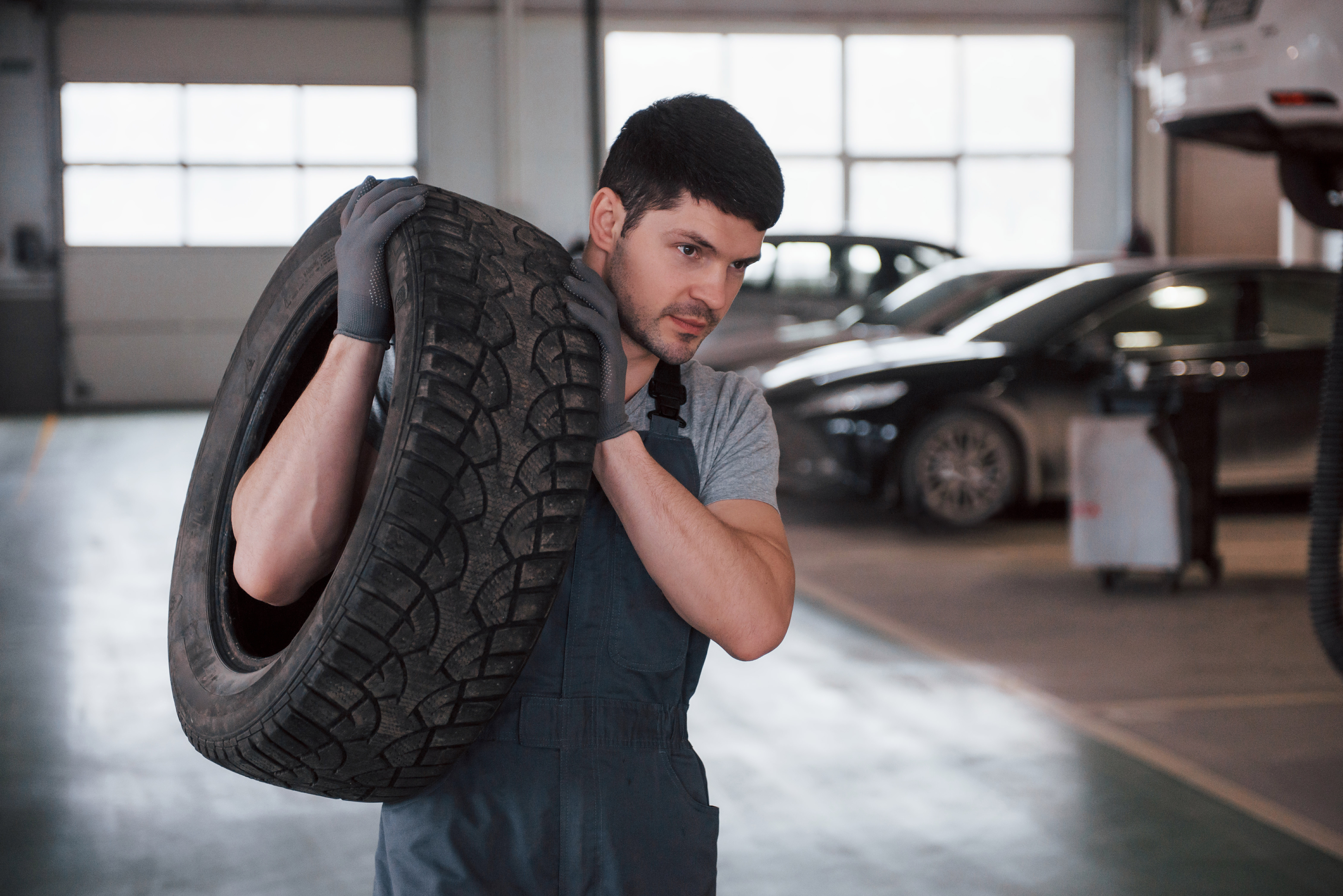 Mechanic holding tire at repair garage